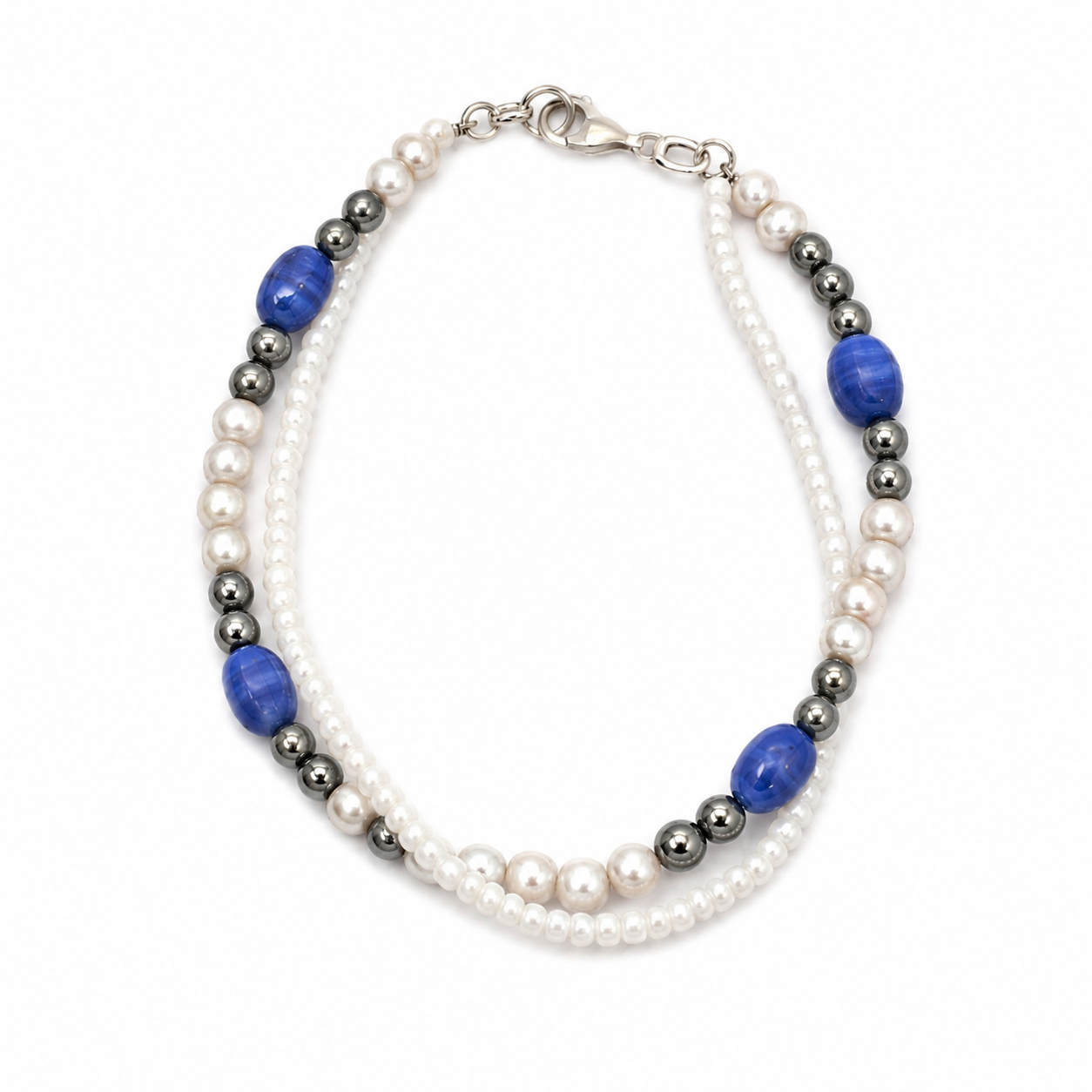 Main - Handmade dual strand bracelet with white seed beads, metallic hematite beads, pearl accents, and royal blue accent beads on a clean white background.