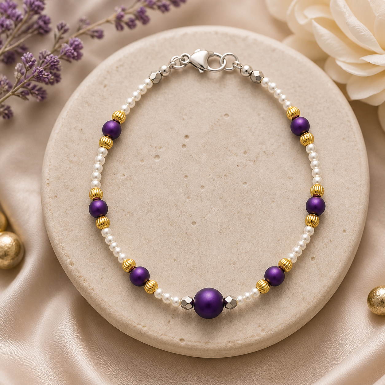 Purple gold and pearl beaded bracelet styled on neutral stone background elegant handmade jewelry
