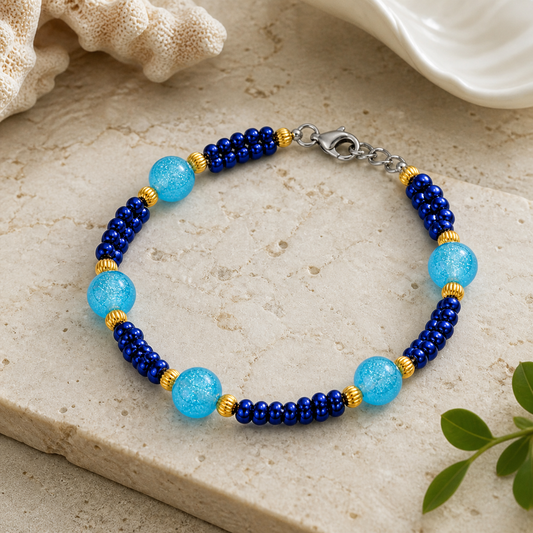 Navy and aqua beaded bracelet styled on neutral stone background elegant handmade jewelry