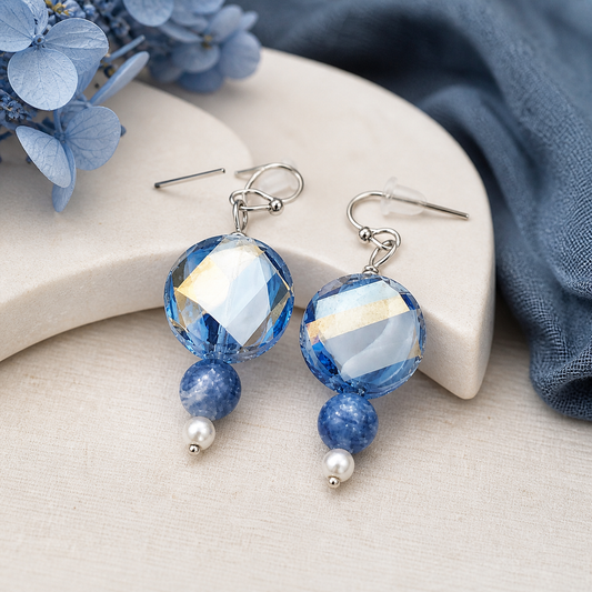 Blue and white faceted earrings styled with soft neutral decor elegant jewelry