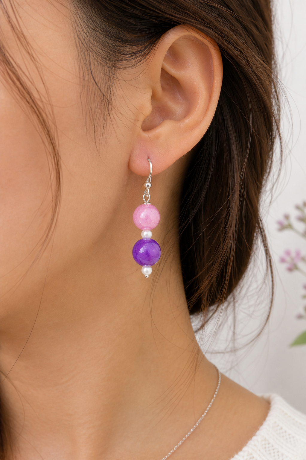 Woman wearing pink and purple bead drop earrings close up lightweight handmade jewelry