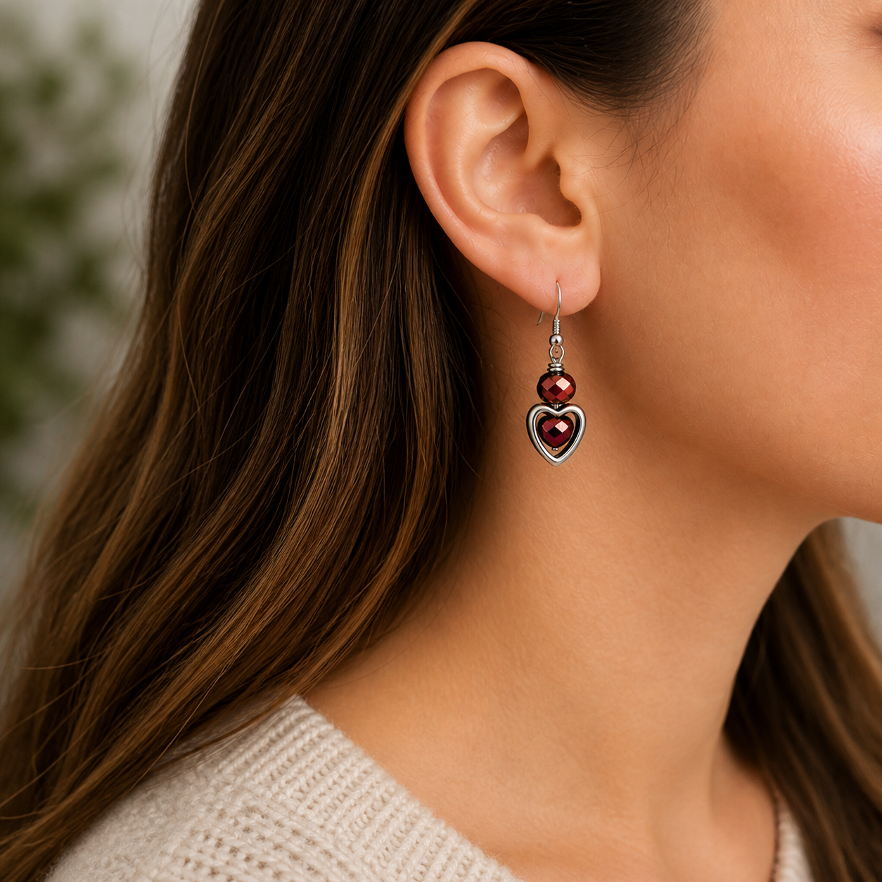 Woman wearing ruby heart dangle earrings close up lightweight jewelry