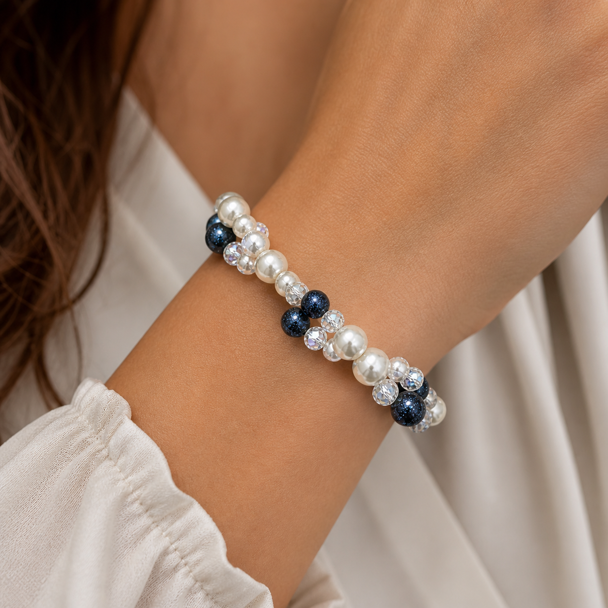 Woman wearing pearl and crystal beaded bracelet with navy accents close up elegant jewelry
