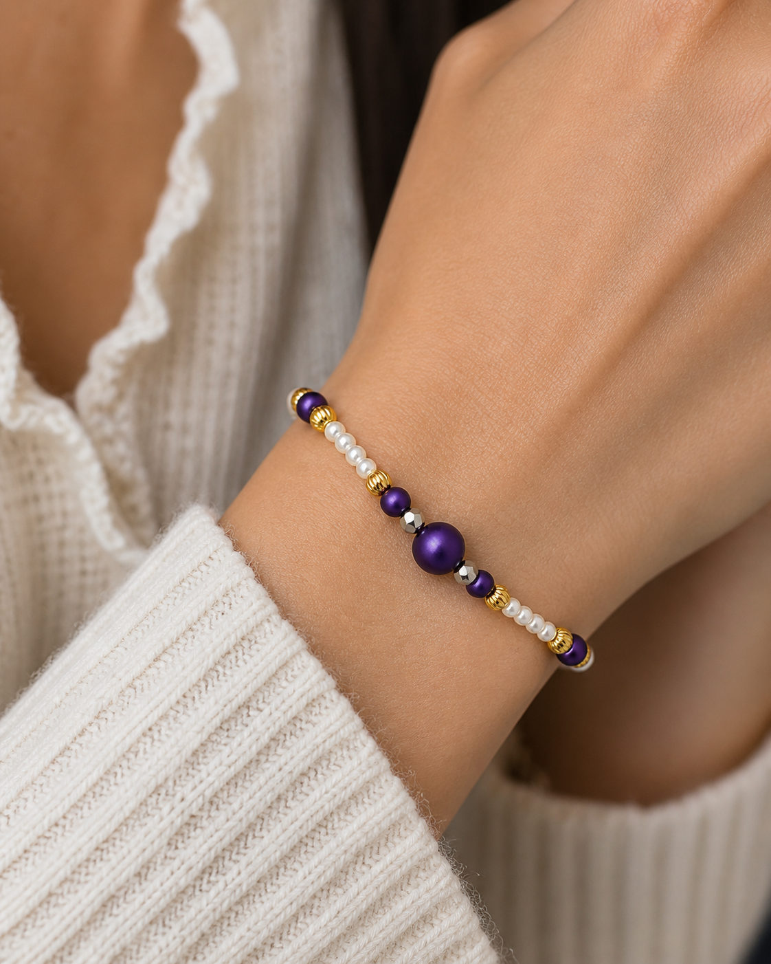 Woman wearing purple gold and pearl beaded bracelet close up elegant lightweight jewelry