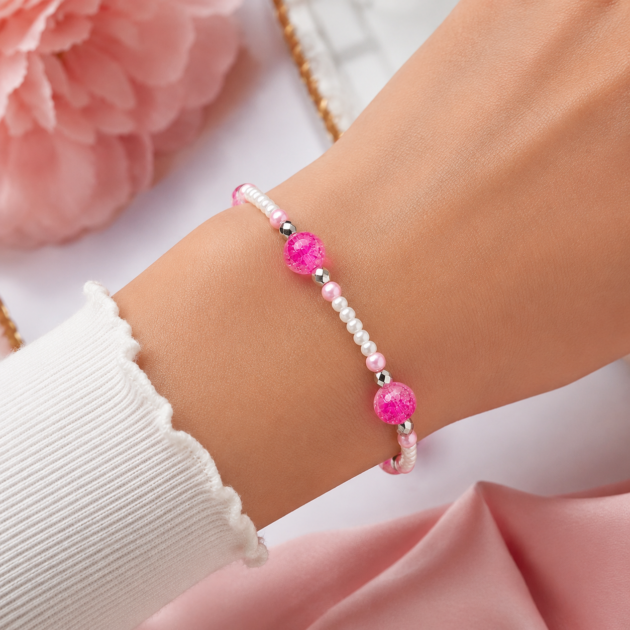 Woman wearing pink crackle bead bracelet with pearl accents close up lightweight stylish jewelry