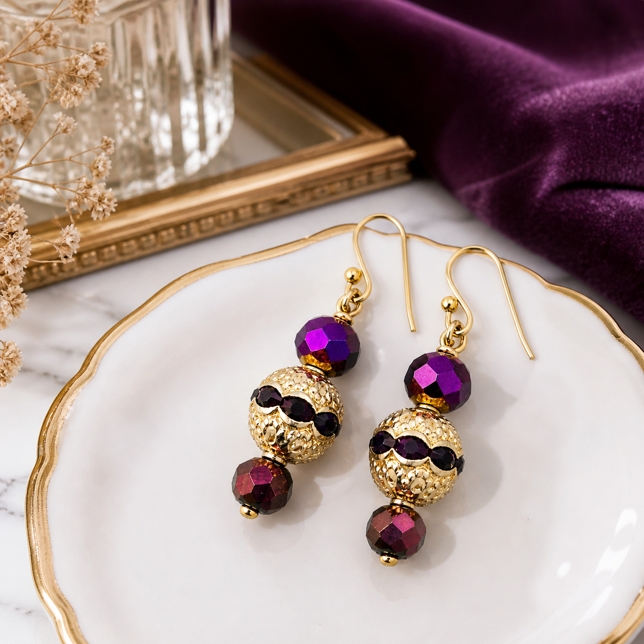 Purple and gold beaded earrings styled on elegant marble and fabric background luxury jewelry