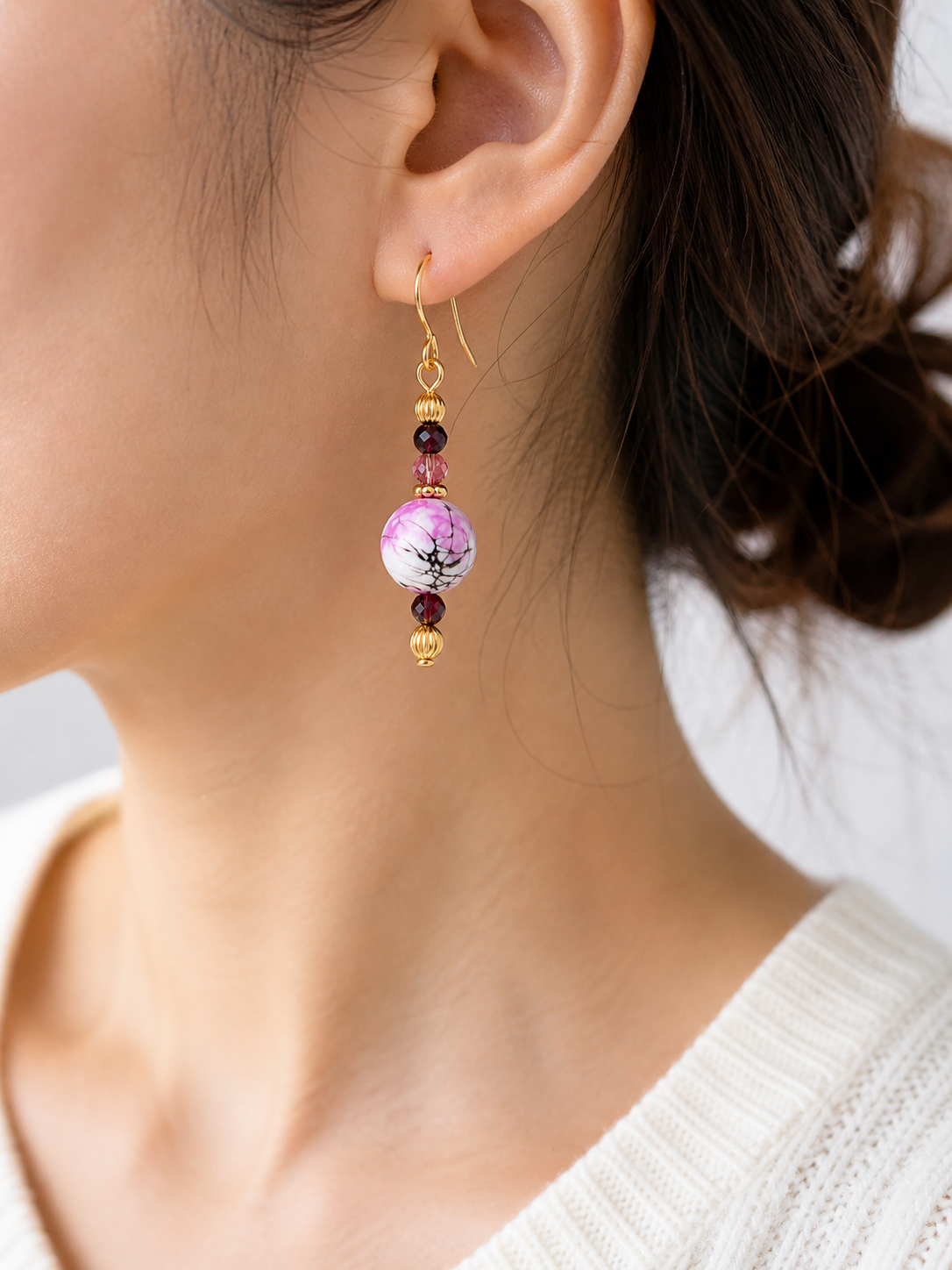 Woman wearing pink marble dangle earrings close up lightweight jewelry