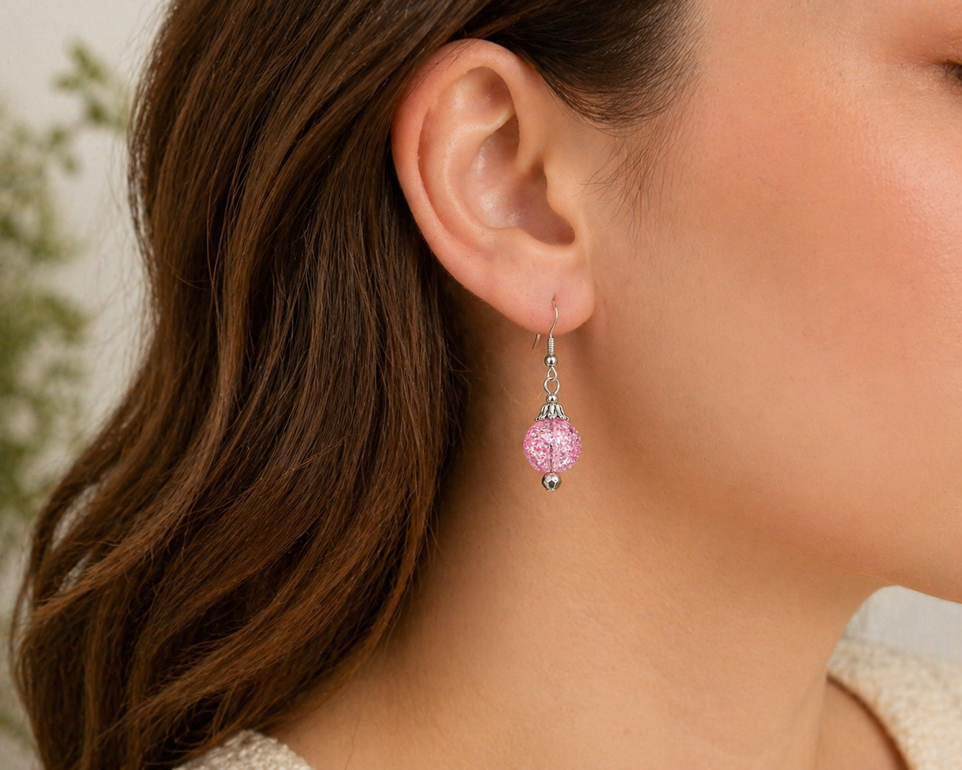 Woman wearing pink sparkle dangle earrings close up lightweight jewelry